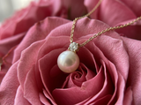 Gifts Under $150 - pearl pendant on blush pink petals