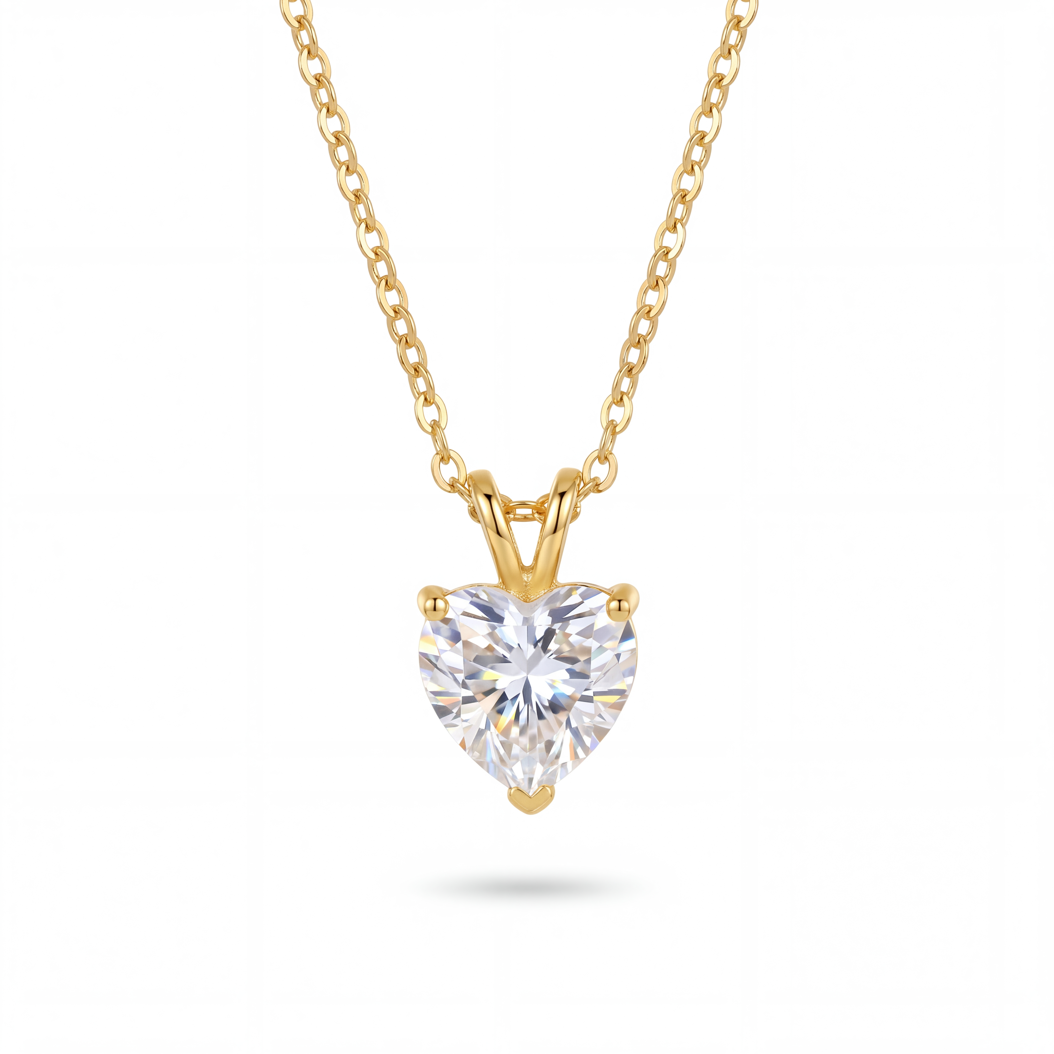 Heart-shaped diamond pendant on a gold chain against a white background