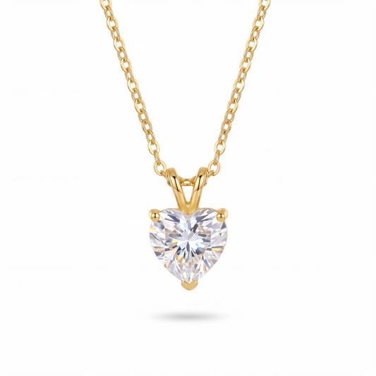 Heart-shaped diamond pendant on a gold chain against a white background