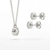 Silver necklace and earrings set on a white background