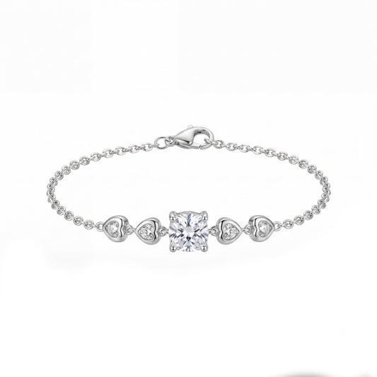 Silver bracelet with heart and square diamond charms on a white background