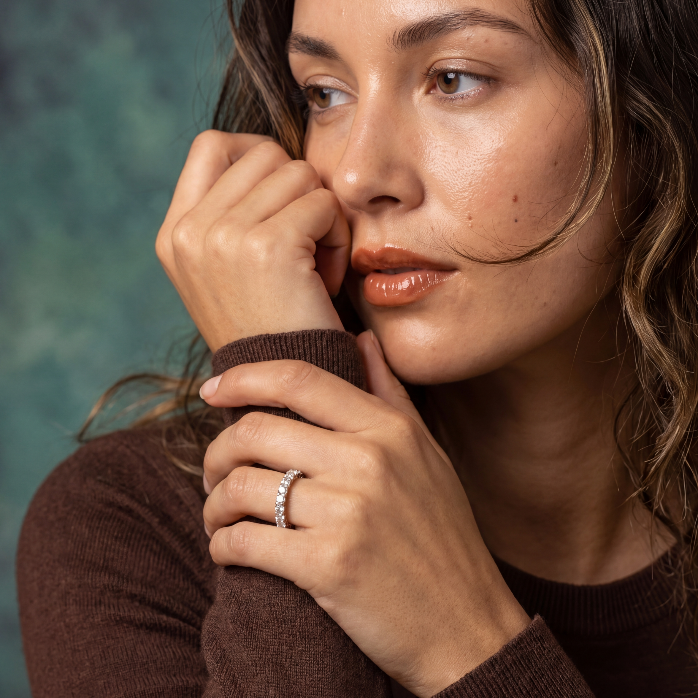 Woman wearing a brown sweater with a blurred background
