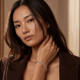 Woman wearing a brown blazer with a neutral background
