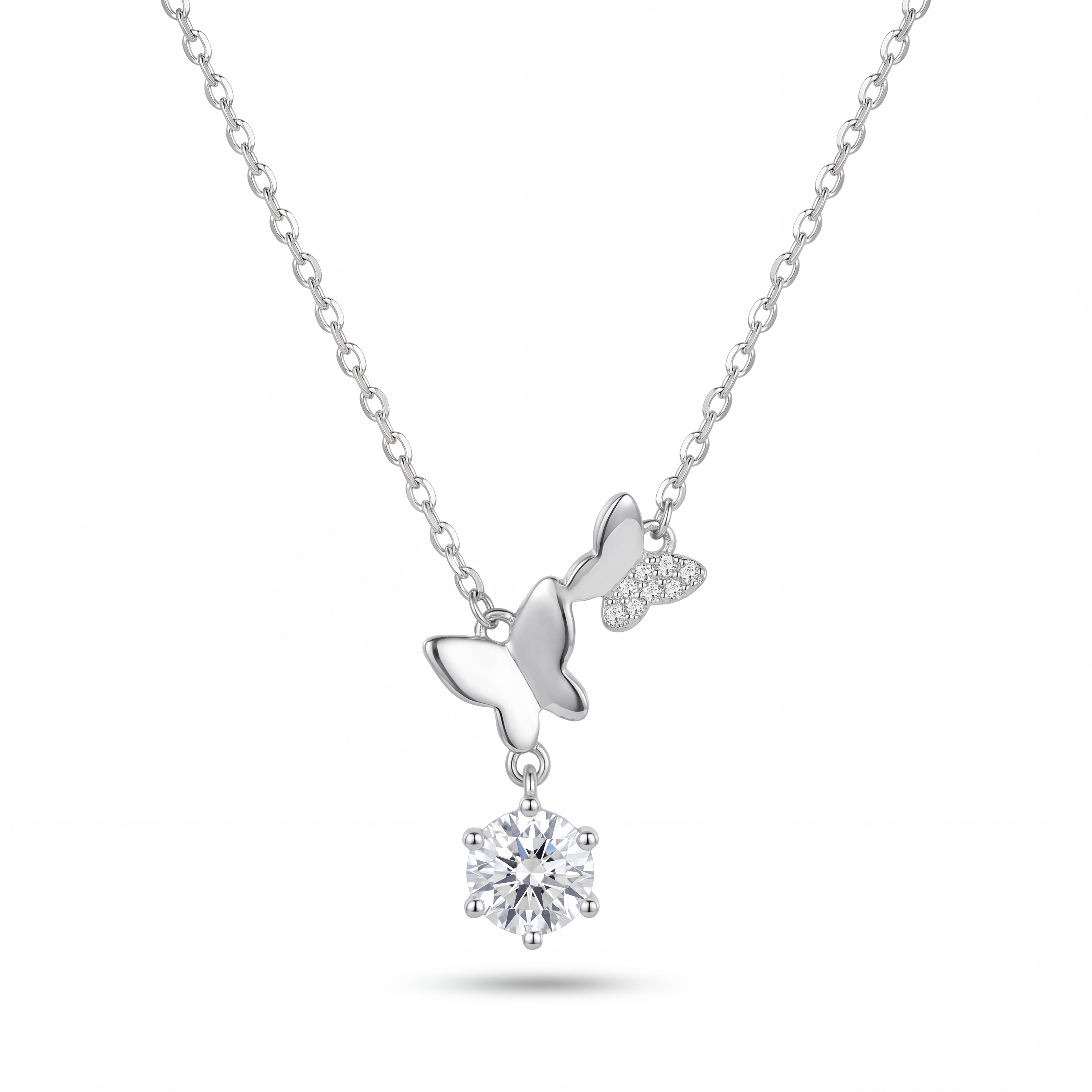 Silver necklace with a bow and round pendant on a white background