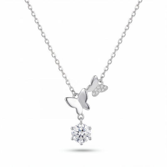 Silver necklace with a bow and round pendant on a white background