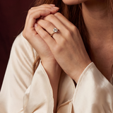 Woman wearing a ring with a maroon background