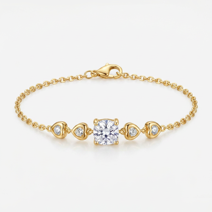 A delicate yellow gold chain bracelet featuring a central square-cut clear gemstone, flanked by three small heart-shaped clear gemstones in gold settings, photographed on a clean white background.