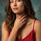 Woman wearing a red dress with a textured blue background