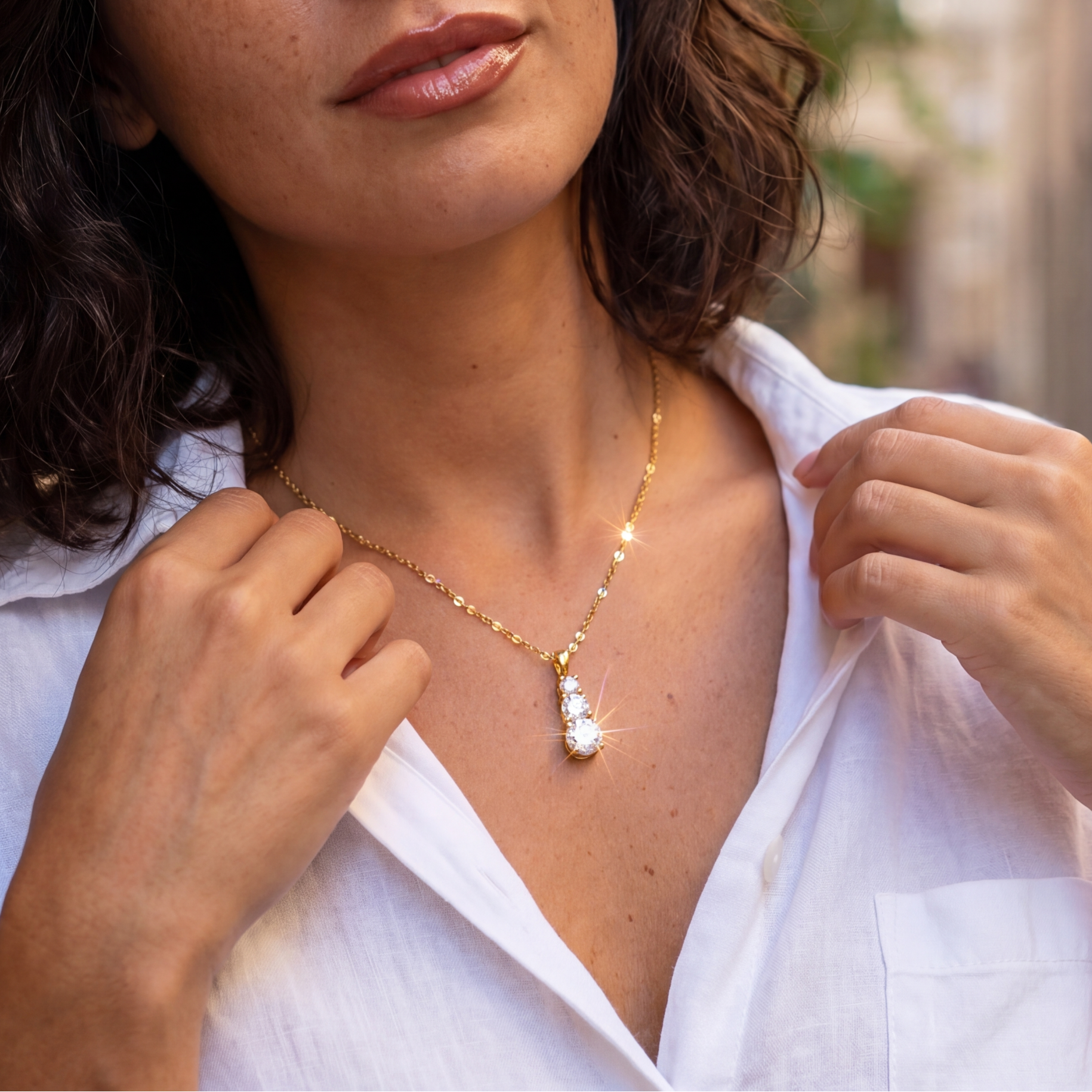 Woman wearing a necklace in an outdoor setting