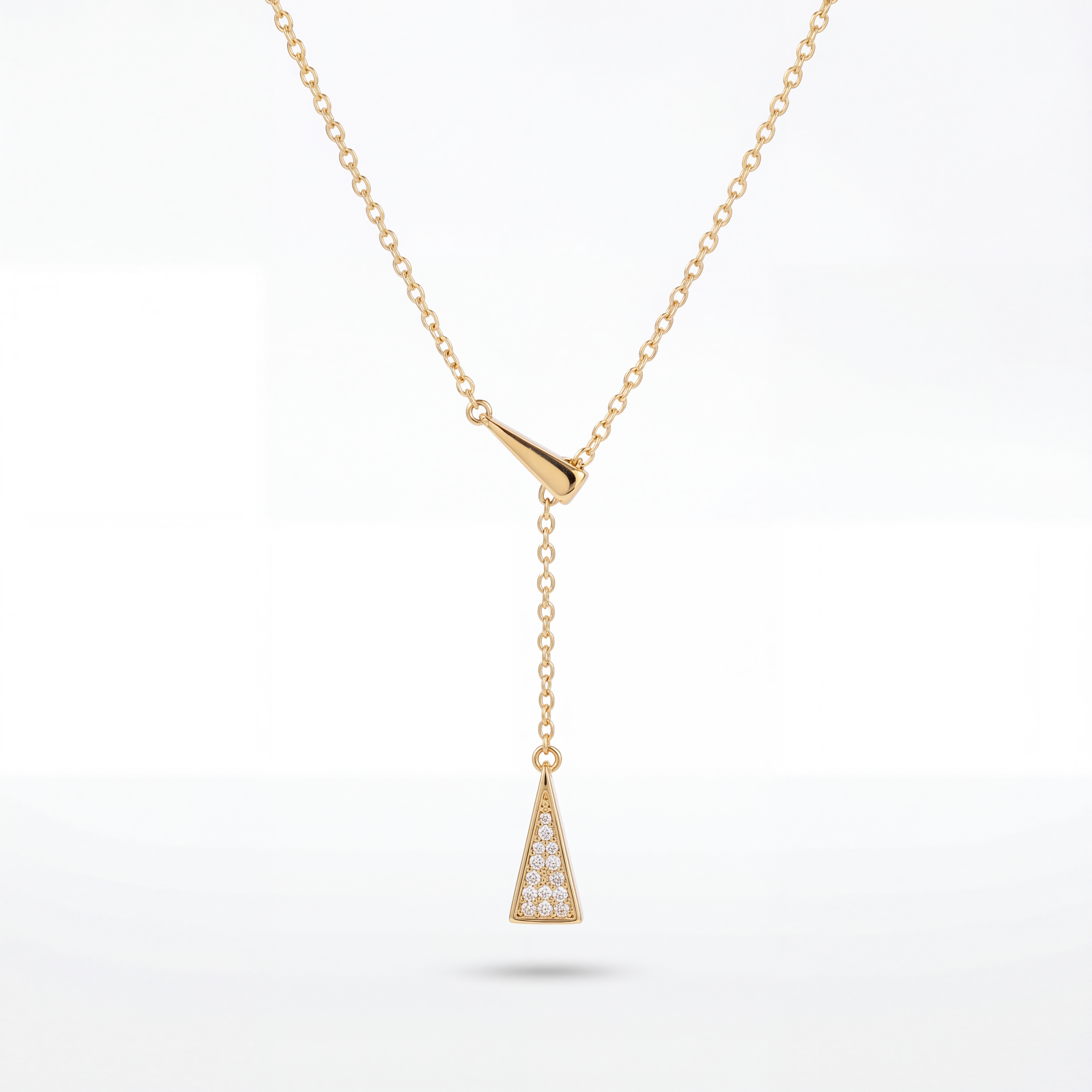 Gold necklace with a triangular pendant on a white background