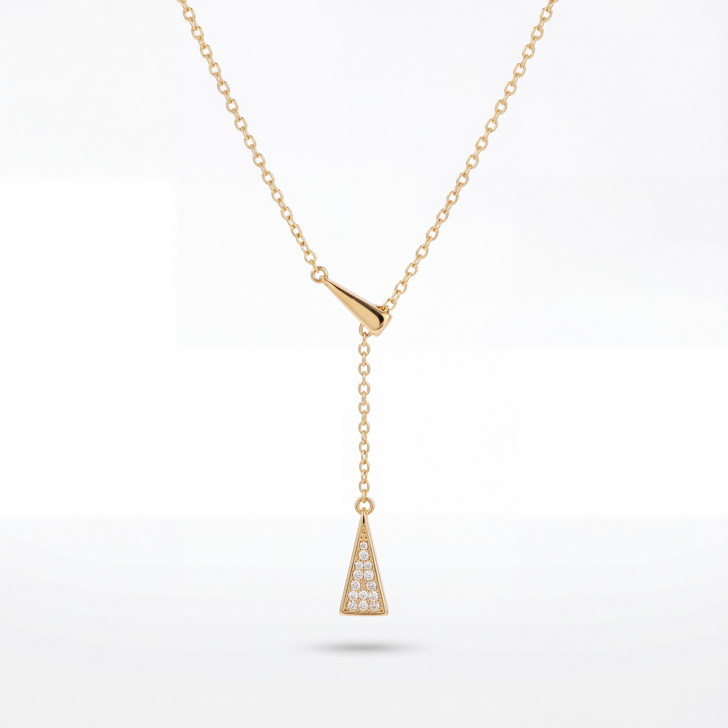 Gold necklace with a triangular pendant on a white background