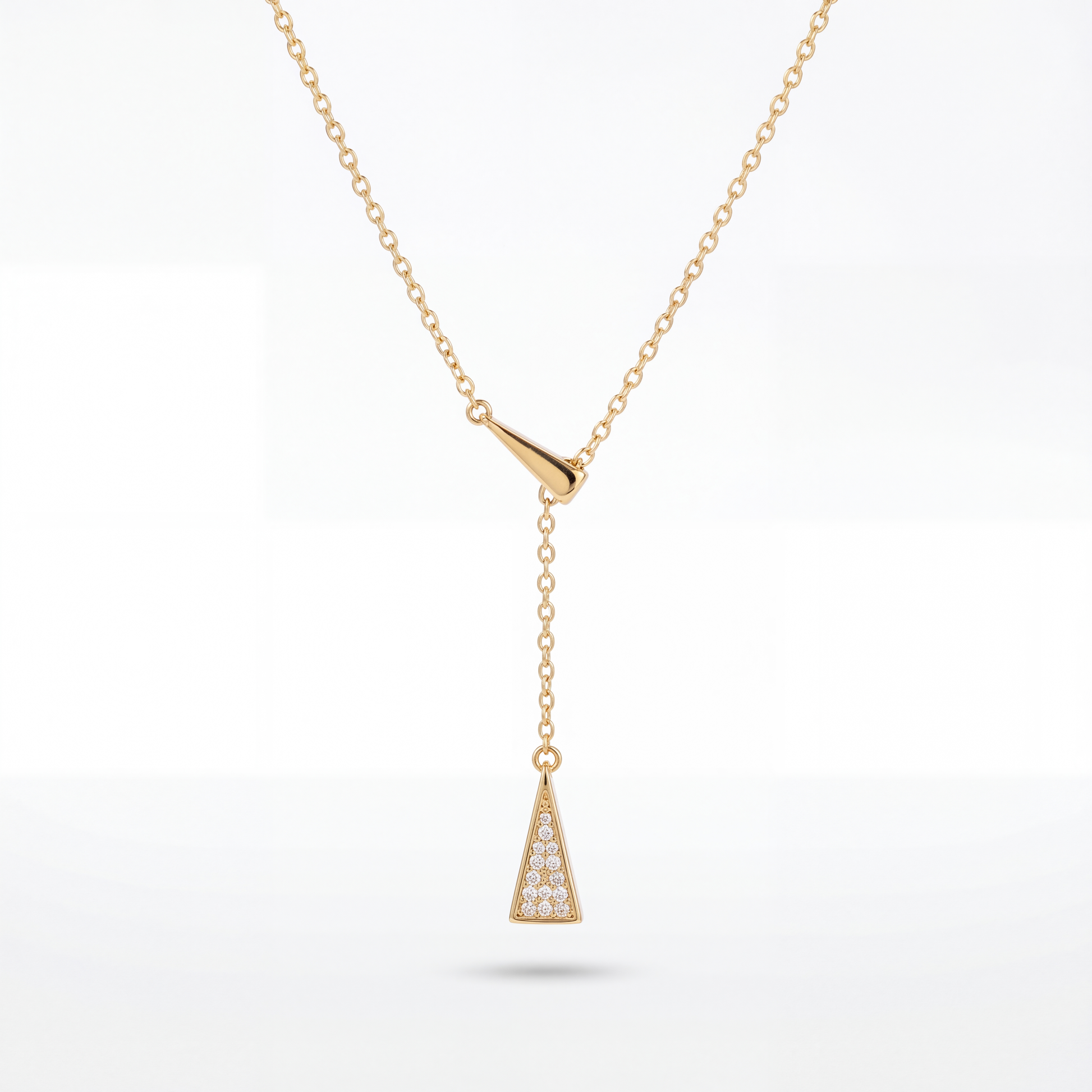 Gold necklace with a triangular pendant on a white background