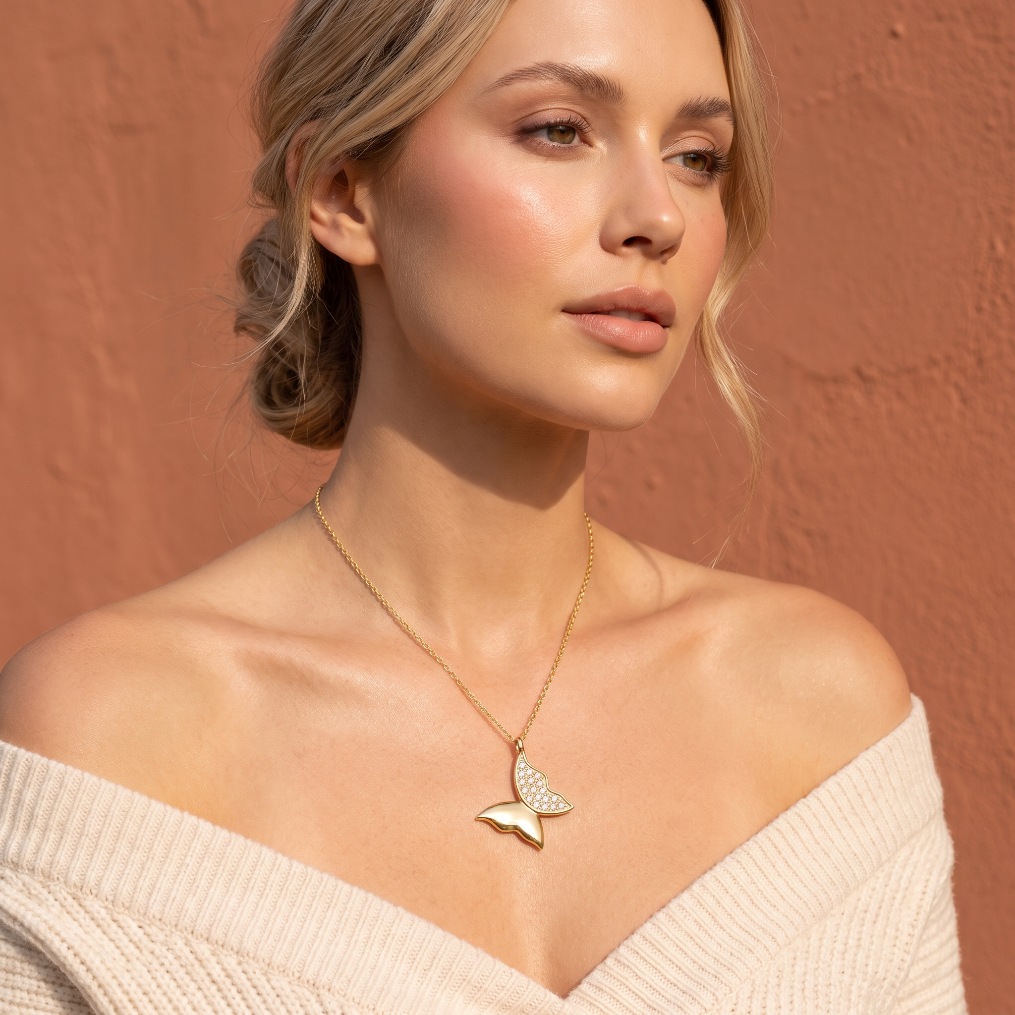 The MOHRA Butterfly Pendant on a delicate adjustable cable chain, worn