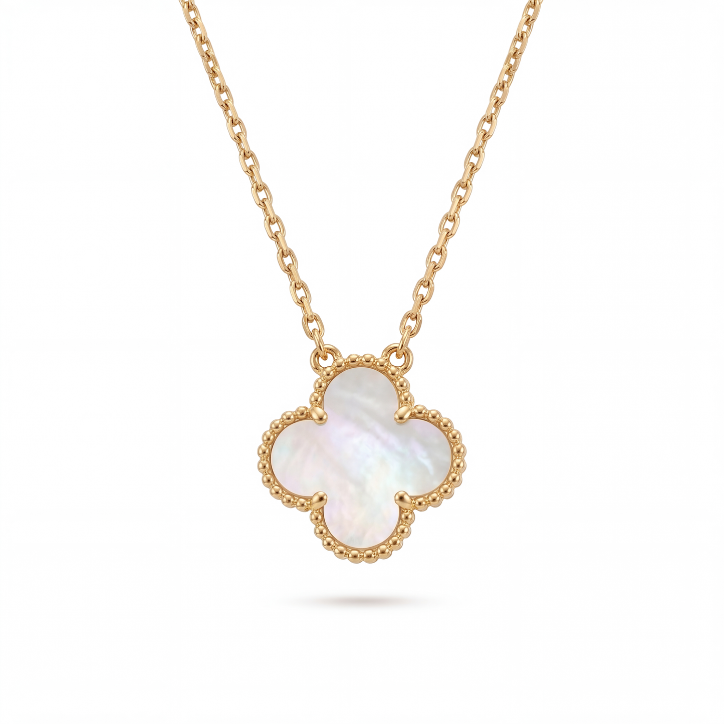 Gold necklace with a clover-shaped pendant on a white background