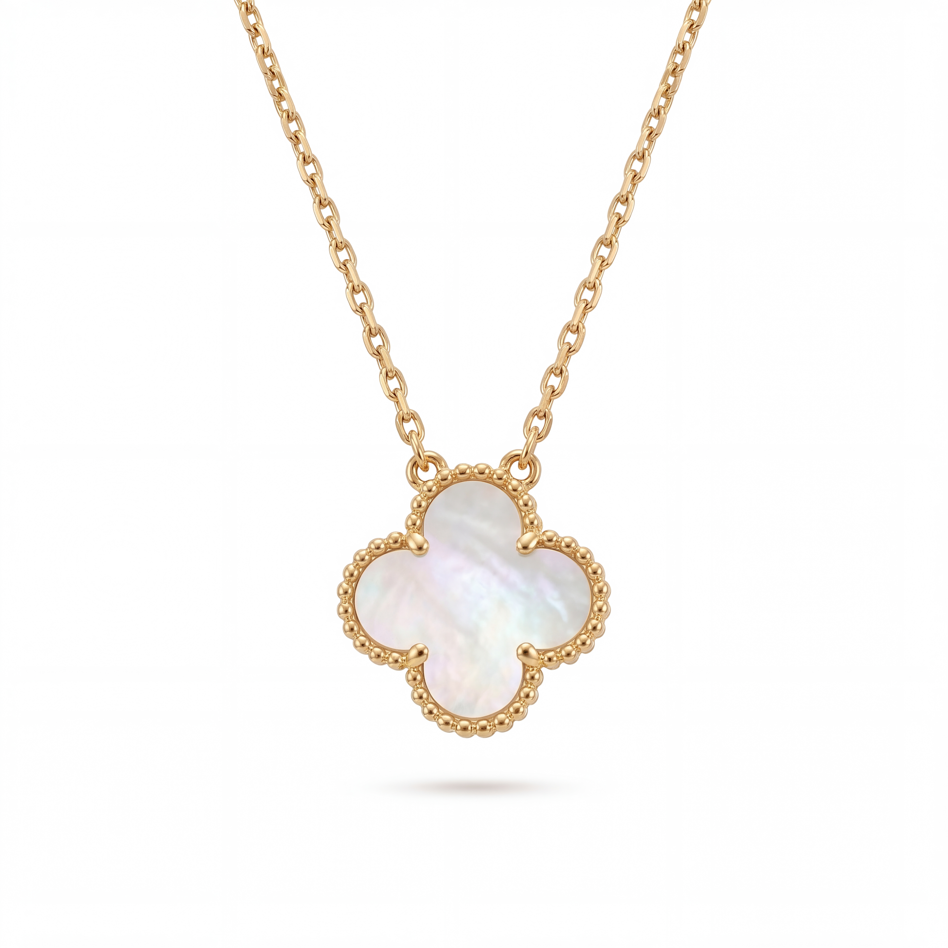 Gold necklace with a clover-shaped pendant on a white background